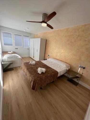 a bedroom with a bed and a ceiling fan at SACABA BEACH SWEET in Málaga