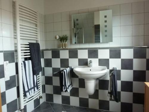 a bathroom with a sink and a mirror at FeWo La Casa - Ferien im Münsterland in Ahaus