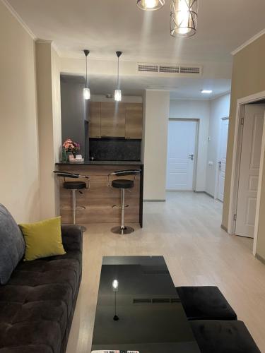 a living room with a couch and a kitchen at Tsaghkadzor Alvina complex in Tsaghkadzor