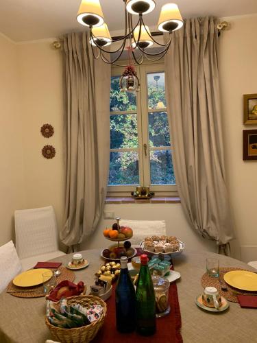 a table with plates of food and a window at Altra Meta b&b in Gubbio