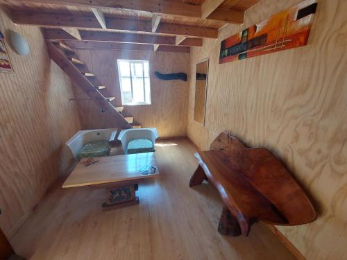 an overhead view of a wooden table and chair in a room at Hostal House FloVer in Puerto Varas