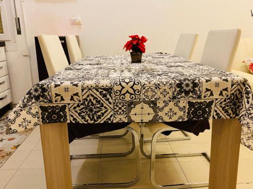 a dining room table with a table cloth on it at Subito disponibile! in Cinisello Balsamo
