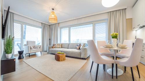 a living room with a couch and a table at Apartament Lux Tukan B002, Polanki Aqua - Holiday City in Kołobrzeg