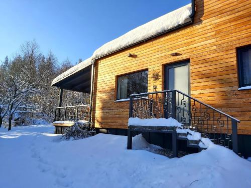 a log cabin in the snow with a balcony at LOFT WAPITI in Hutisko