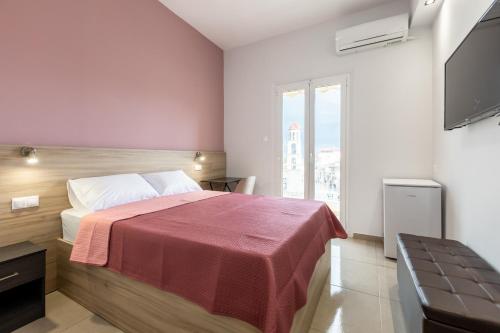 a bedroom with a bed with a red blanket at ATHENAIS CENTRAL by OLYMPUS PANTHEON in Litochoro