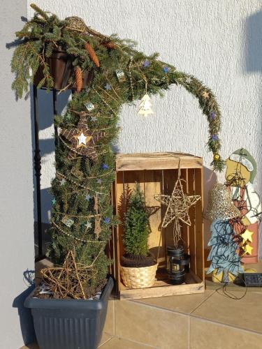 a small christmas display with a christmas tree in a pot at Constantin Panzió in Praid