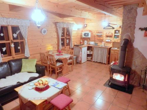 a living room with a wood stove in a cabin at Liptovská Drevenica in Liptovský Mikuláš