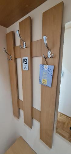 a room with three wooden doors with a sign on it at Design Apartment BUSINESS LUX 4 STAR "RIO" Completely Business LUX place in the City Center & FREE INCLUDED Industry optical WiFi & NETFLIX & Keyless code entry & FULL SMART APP & Kitchen & Washing machine & Wide terrace & SECURE 2 Parking place in Ćuprija
