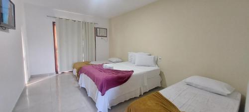 A bed or beds in a room at Pousada Porto Feliz