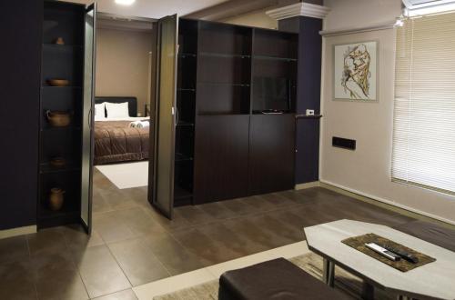 a living room with a bed and a large glass door at Hotel Ambasador in Bitola