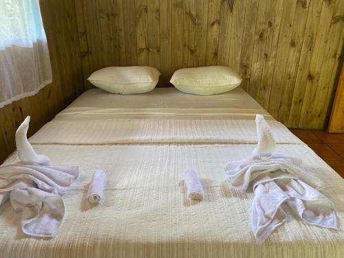 a bed with towels on it in a room at Sabalo Lodge Tours and Cabins in Sierpe