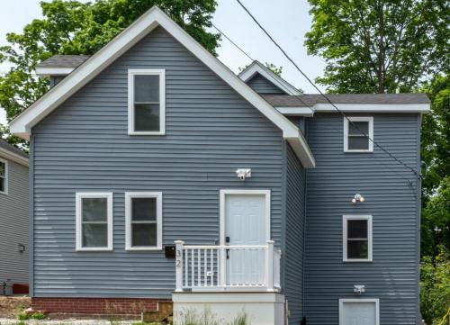 a blue house with a white front porch at Queen Bed - Boston - RM 3 in Stoneham