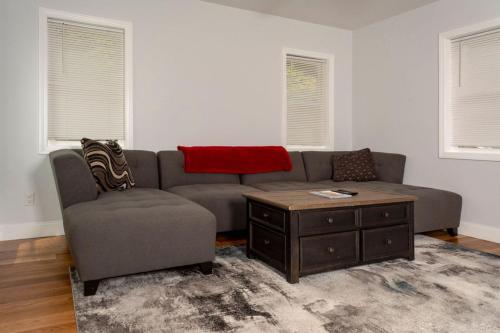 a living room with a couch and a coffee table at Queen Bed - Boston - RM 3 in Stoneham