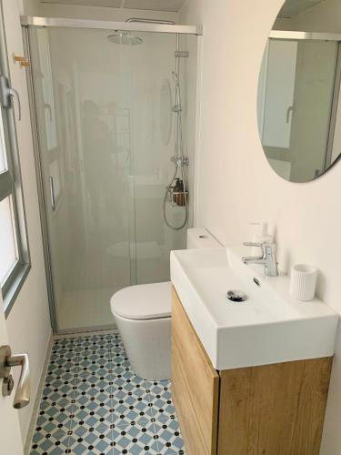 a bathroom with a toilet and a sink and a mirror at SAN LORENZO HUESCA con parking in Huesca