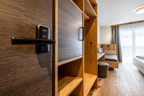 a door in a room with a bed and a bedroom at Gästehaus Mirzl in Schladming