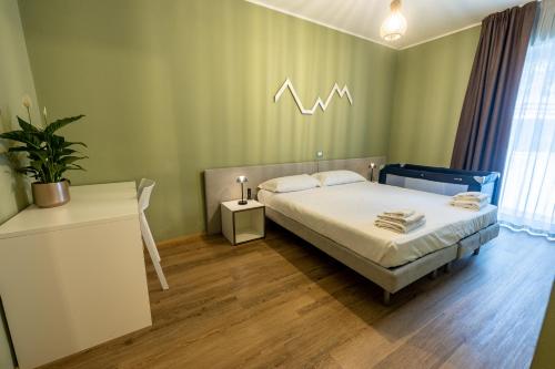 Ένα ή περισσότερα κρεβάτια σε δωμάτιο στο Hotel Casa Alpina
