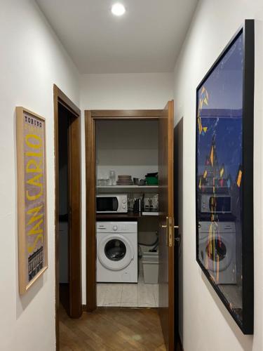 a kitchen with a washer and dryer in a room at Appartamento Cenisia Fermata Racconigi in Turin