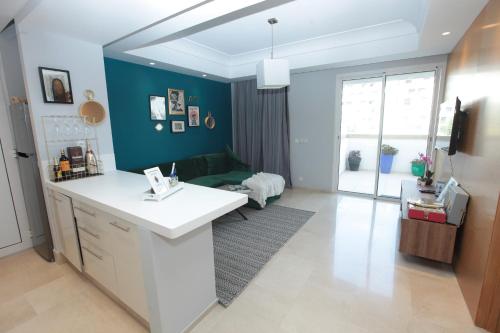 a kitchen with a white counter and a green wall at Joumaya White & See in Casablanca