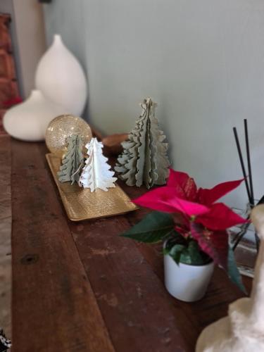 a table with some christmas decorations on it at La Maison de Lyna - Suites de charme intra-muros avec parking & autonomie in Aigues-Mortes