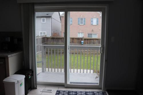 a sliding glass door with a view of a yard at Entire 4 bed room detached residential home in Ajax