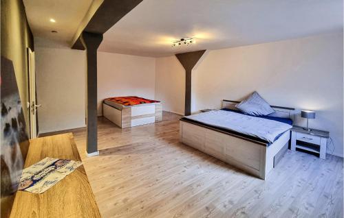 a bedroom with two beds and a table at 2 Bedroom Cozy Apartment In Kltze in Klötze