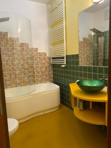 a bathroom with a sink and a tub and a toilet at Sunny Life Apartment in Warsaw