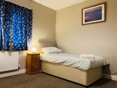 a small bedroom with a bed and a window at Cosy home near hospital in Carlisle