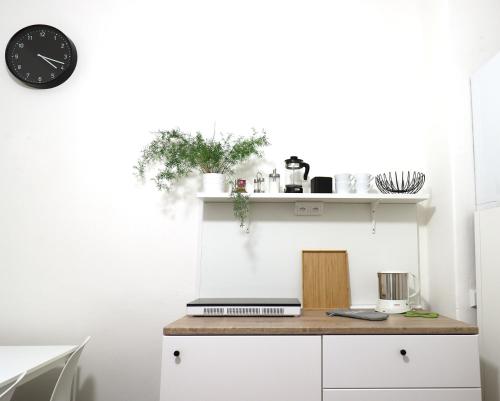 a kitchen with a counter and a clock on a wall at Teytz Apartments in Prague