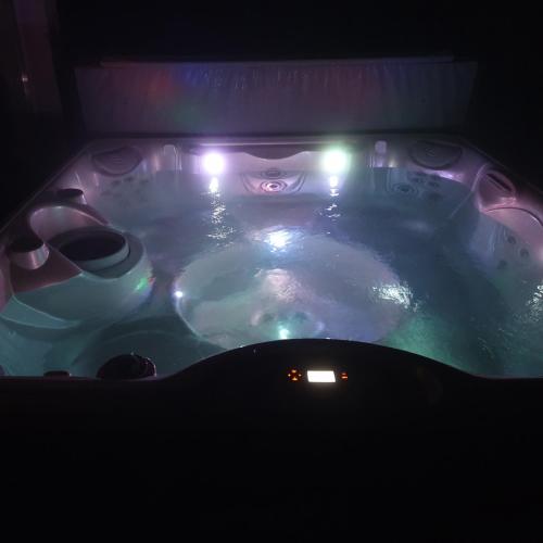 a hot tub with lights in a dark room at MaZso vendégház Balatonakarattya in Balatonakarattya