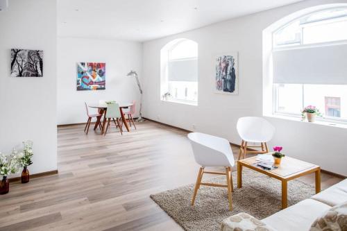 a living room with white walls and wooden floors at Family friendly, Free Parking, in Best Part of the City in Ålesund