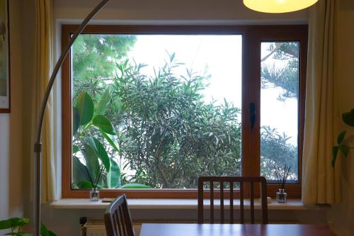 a window with a table and chairs in front of it at Fira Central Apartments with Veranda in Fira