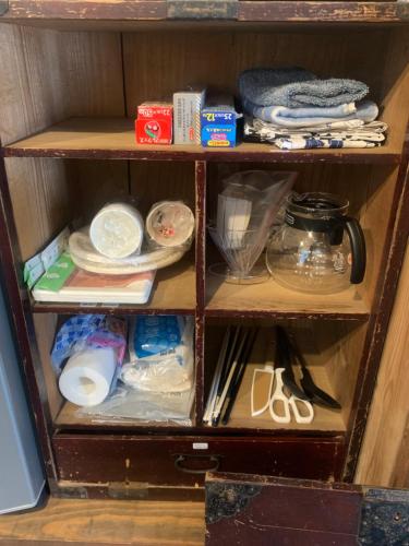 a wooden shelf with dishes and other items on it at 囲炉裏町家Guesthouse FUJITA 一棟貸切 villa 無料駐車場 in Hakusan