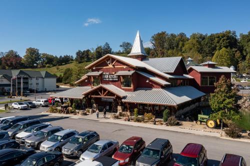 a parking lot with cars parked in front of a building at 5Bd5B Escape Cabin with 2 HotTubs, Thtr &Game Rm,1mi to the Parkway! 4mi to Dollywood - Spring Deal in Pigeon Forge