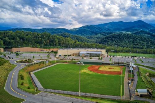 an empty baseball field with mountains in the background at 5Bd5B Escape Cabin with 2 HotTubs, Thtr &Game Rm,1mi to the Parkway! 4mi to Dollywood - Spring Deal in Pigeon Forge