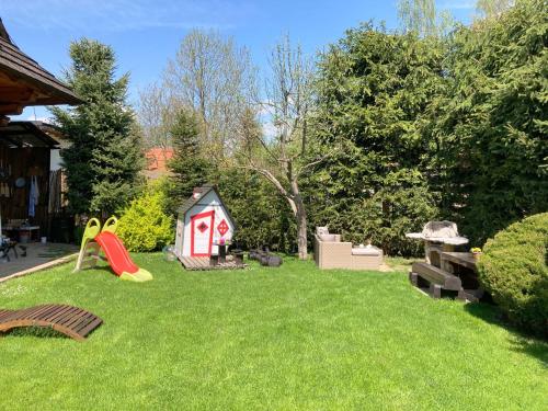 a yard with a play house and a playground at Liptovská Drevenica in Liptovský Mikuláš