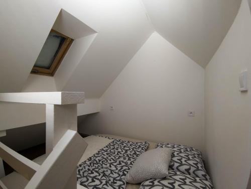 a small room with a bed and a staircase at Apartments Křišťanova in Prague
