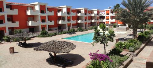 an apartment complex with a swimming pool and a resort at Sal service red moradias residence with pool in Santa Maria