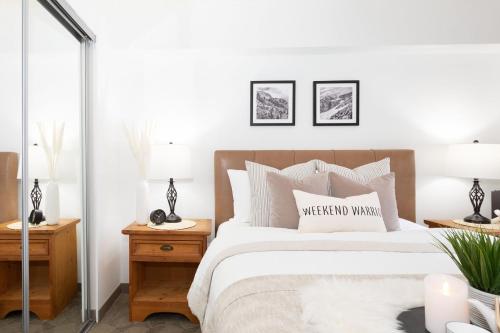 a bedroom with a bed and two tables with lamps at Slopeside Whistler Creek in Whistler