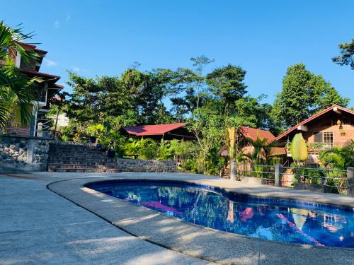 a swimming pool in the middle of a road next to a house at La Casa del Rio B&B in Puyo