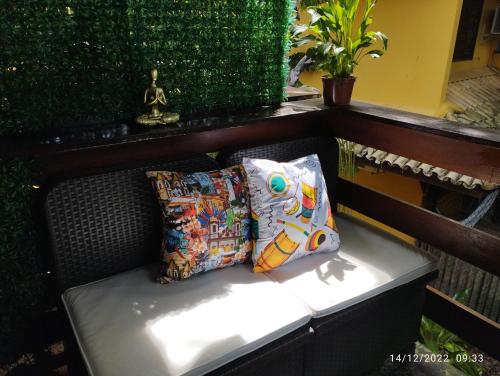 a bench with two pillows sitting on it at Apartamento Praia do Forte in Mata de Sao Joao