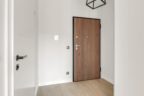 a door in a room with white walls at Dom & House - Apartments Old Town Scala in Gdańsk