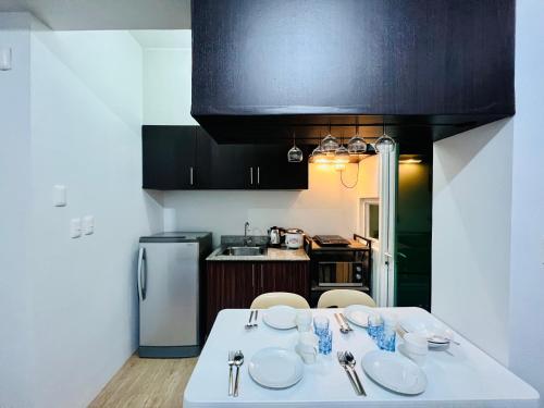 A kitchen or kitchenette at At Home Condo With Free Pool Access