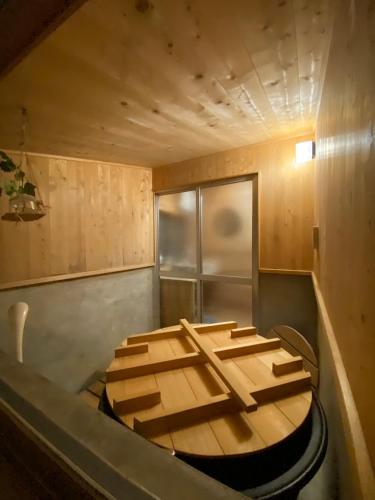 a sauna with a wooden floor in a room at 体験型古民家宿 旅ノ舎 in Nissaka