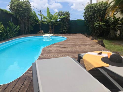 a swimming pool with a table and a bench next to it at DUCHARMOY LODGES in Saint-Claude