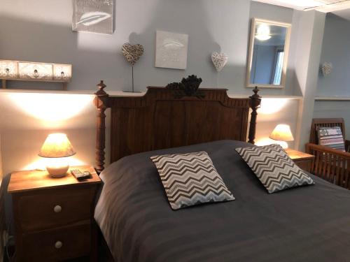a bedroom with a bed with two pillows on it at DUCHARMOY LODGES in Saint-Claude