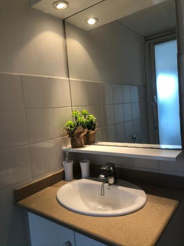 a bathroom with a sink and a mirror at DUCHARMOY LODGES in Saint-Claude