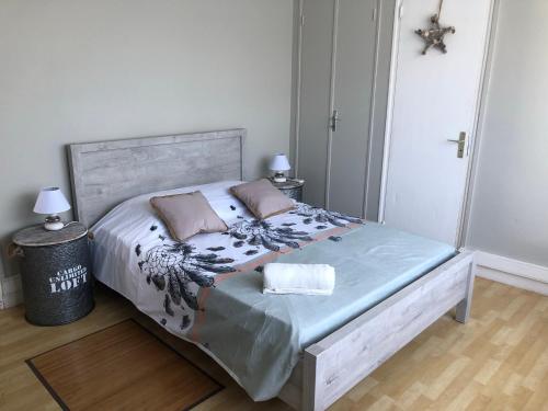 a bedroom with a bed with two pillows on it at DUCHARMOY LODGES in Saint-Claude
