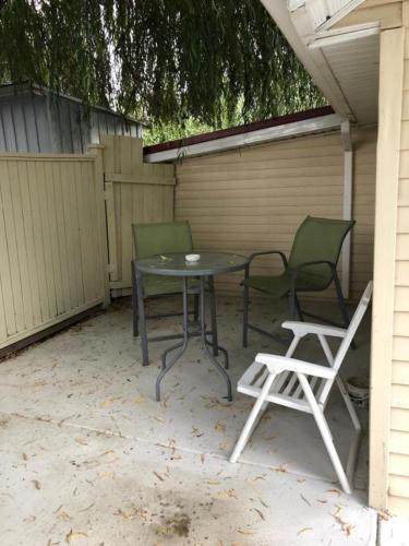 a patio with a table and two chairs and a table and chairs at Shady Willow Guest House - SMALL Indipendent Units with Seperate Entrance for Travellers in Chilliwack