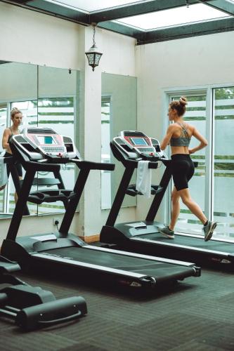 a woman running on a treadmill in a gym at Heritage Hotel Cameron Highlands in Cameron Highlands
