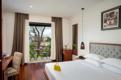Ein Bett oder Betten in einem Zimmer der Unterkunft Koulen Hotel